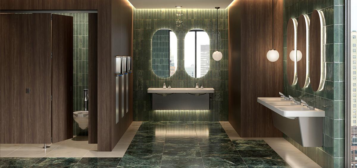 Modern commercial restroom with wood-grain toilet partitions, green tile walls, backlit oval mirrors and multi-station sinks.